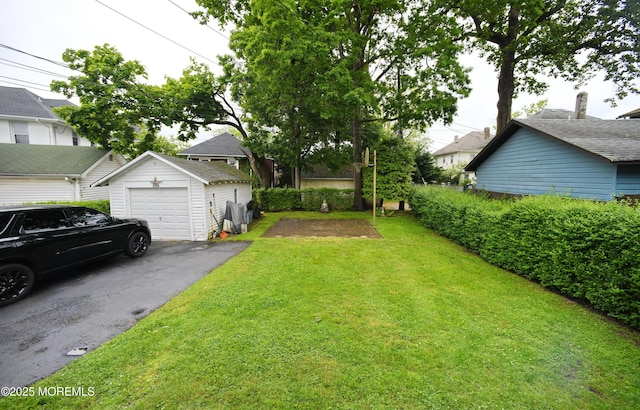 503 Page Ave, Allenhurst, NJ 07711 - view of green lawn with an outdoor structure, driveway, and a detached garage