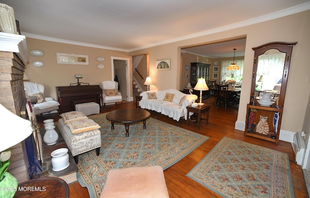 503 Page Ave, Allenhurst, NJ 07711 - living room with ornamental molding, stairs, wood finished floors, a baseboard heating unit, and a fireplace