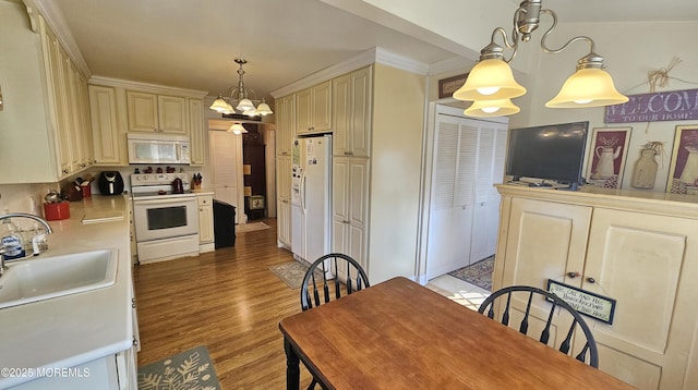 503 Page Ave, Allenhurst, NJ 07711 - kitchen with white appliances, cream cabinetry, light countertops, light wood-type flooring, and hanging light fixtures