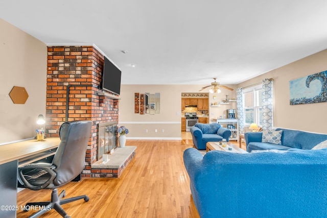 21 Clearwater Way, Toms River, NJ 08753 - living room featuring a fireplace, light wood-type flooring, baseboards, ceiling fan, and a desk