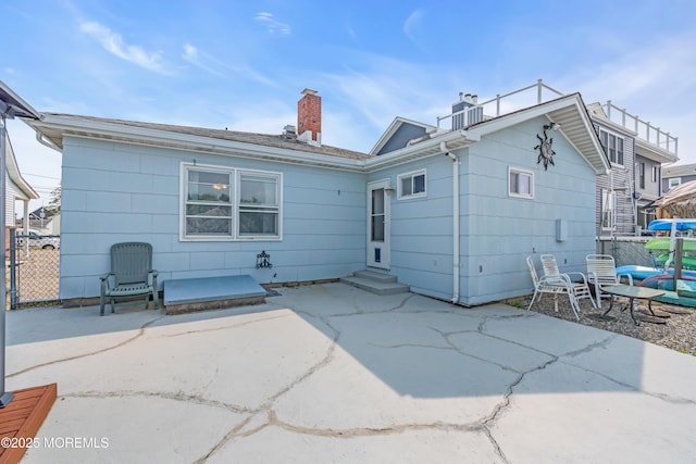 21 Clearwater Way, Toms River, NJ 08753 - back of house with entry steps, a patio, and a chimney