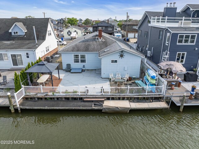 21 Clearwater Way, Toms River, NJ 08753 - back of house featuring outdoor dining area, a residential view, a gazebo, a patio area, and a fenced backyard