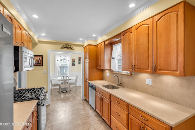 143 Emerson St, Carteret, NJ 07008 - kitchen with stainless steel appliances, a sink, ornamental molding, brown cabinets, and light stone countertops