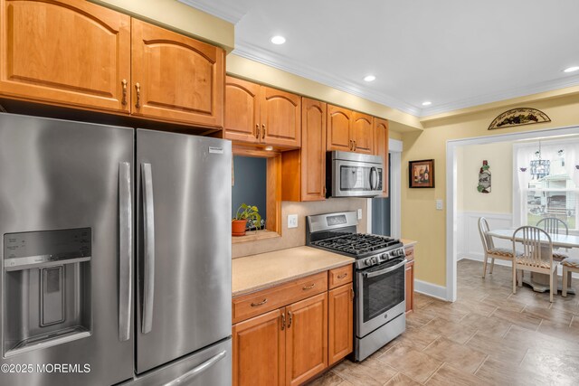 143 Emerson St, Carteret, NJ 07008 - kitchen featuring stainless steel appliances, light countertops, crown molding, recessed lighting, and wainscoting
