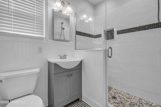 143 Emerson St, Carteret, NJ 07008 - bathroom with a shower stall, toilet, vanity, and wainscoting