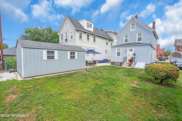 143 Emerson St, Carteret, NJ 07008 - back of house featuring an outbuilding, a chimney, entry steps, and a patio