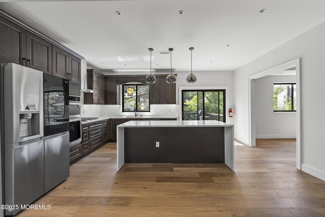 4 Penny Ct, East Brunswick, NJ 08816 - kitchen with appliances with stainless steel finishes, a center island, a sink, decorative backsplash, and dark brown cabinets