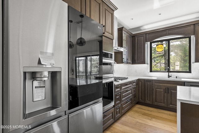 4 Penny Ct, East Brunswick, NJ 08816 - kitchen with a sink, tasteful backsplash, light wood-style flooring, dark brown cabinets, and stainless steel gas cooktop