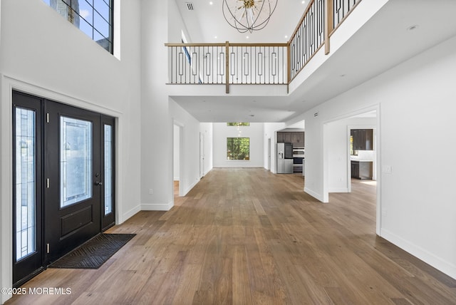 4 Penny Ct, East Brunswick, NJ 08816 - entrance foyer featuring a high ceiling, baseboards, wood finished floors, and a chandelier