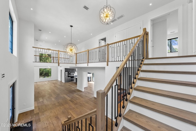 4 Penny Ct, East Brunswick, NJ 08816 - staircase featuring a chandelier, a high ceiling, wood finished floors, healthy amount of natural light, and recessed lighting