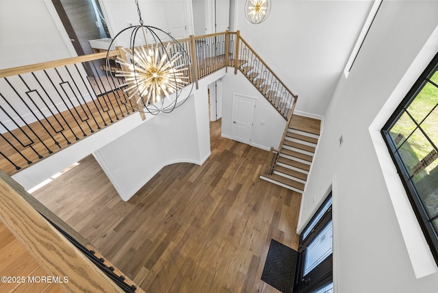 4 Penny Ct, East Brunswick, NJ 08816 - stairs featuring a chandelier, a towering ceiling, and wood finished floors