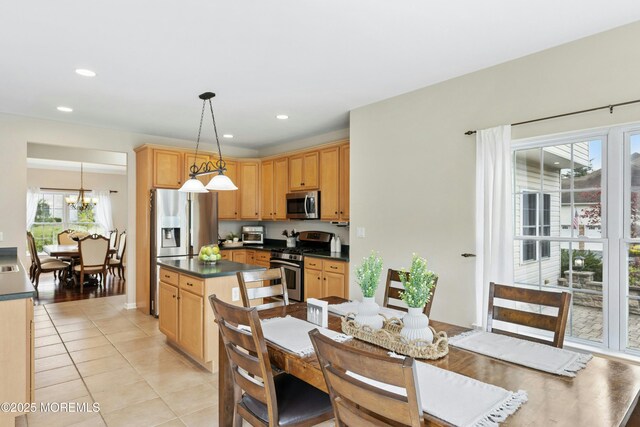 7 Topaz Dr, Jackson, NJ 08527 - kitchen with stainless steel appliances, dark countertops, light tile patterned floors, hanging light fixtures, and a chandelier