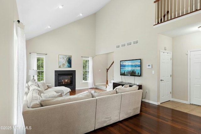 7 Topaz Dr, Jackson, NJ 08527 - living room with stairs, high vaulted ceiling, wood finished floors, and a glass covered fireplace