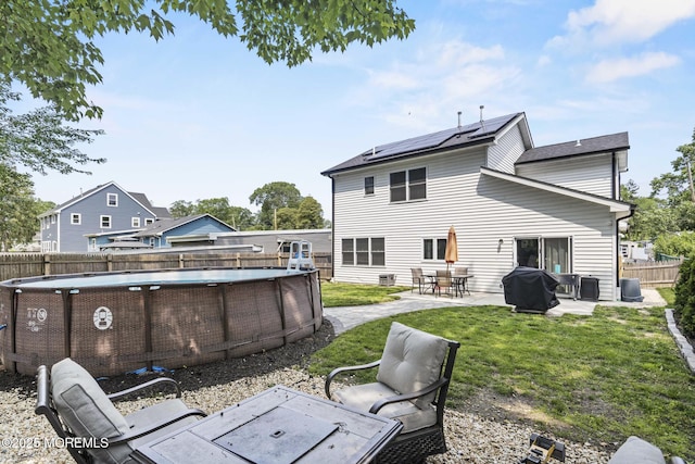 62 E 5th St, Howell, NJ 07731 - rear view of house featuring solar panels and a patio