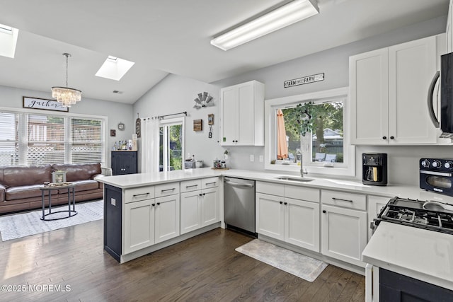 62 E 5th St, Howell, NJ 07731 - kitchen featuring a skylight, dishwasher, a sink, a peninsula, and vaulted ceiling