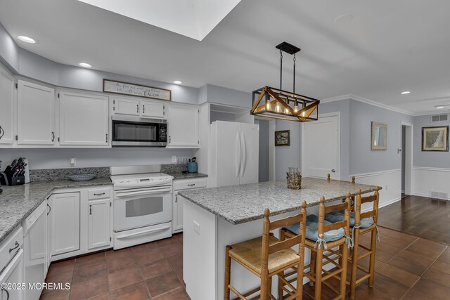 7 Elizabeth Pkwy, Eatontown, NJ 07724 - kitchen with white appliances, white cabinets, crown molding, light stone counters, and recessed lighting