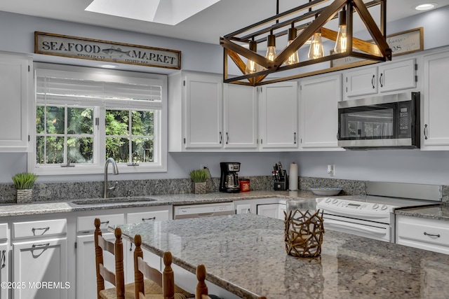 7 Elizabeth Pkwy, Eatontown, NJ 07724 - kitchen with white appliances, a sink, white cabinets, and a skylight