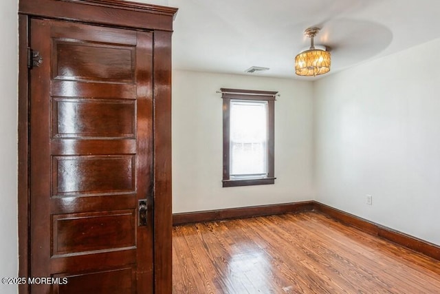 147 Joseph St, East Brunswick, NJ 08816 - spare room with wood finished floors and a chandelier