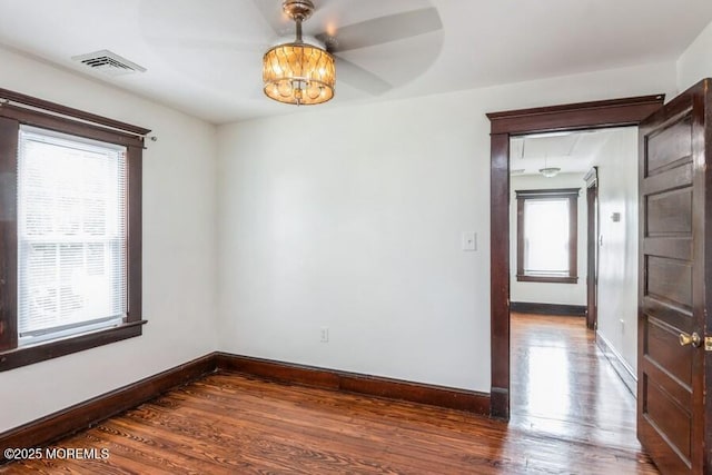 147 Joseph St, East Brunswick, NJ 08816 - unfurnished room with healthy amount of natural light, wood finished floors, and a chandelier