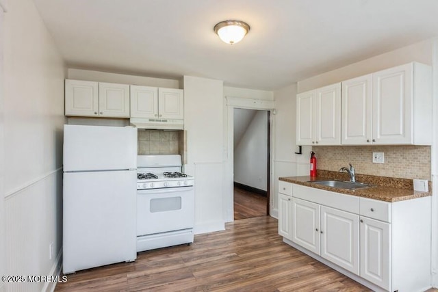 147 Joseph St, East Brunswick, NJ 08816 - kitchen featuring white appliances, under cabinet range hood, tasteful backsplash, and white cabinets