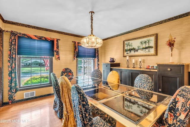 330 Green Grove Rd, Ocean Twp, NJ 07712 - dining area with light wood-type flooring and crown molding