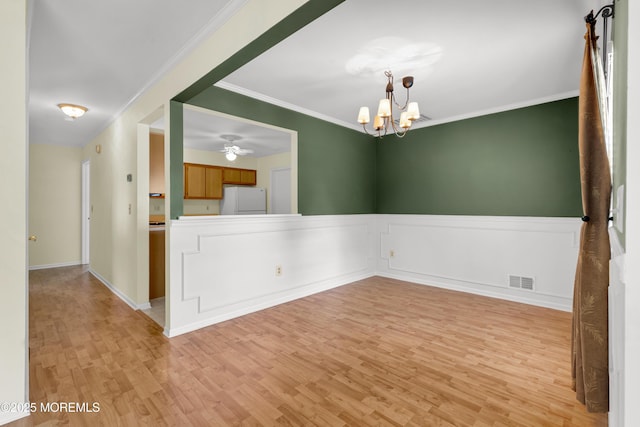 11 Adler Cir, Lumberton, NJ 08048 - unfurnished room featuring light wood-style flooring, ornamental molding, a chandelier, a ceiling fan, and a wainscoted wall
