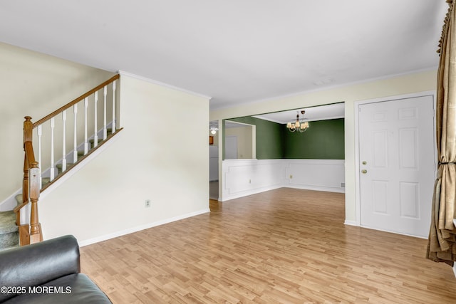 11 Adler Cir, Lumberton, NJ 08048 - unfurnished living room with a chandelier, light wood-type flooring, stairs, crown molding, and wainscoting