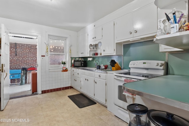 1020 Raritan Ave, Highland Park, NJ 08904 - kitchen featuring white range with electric stovetop, white cabinets, open shelves, and a sink