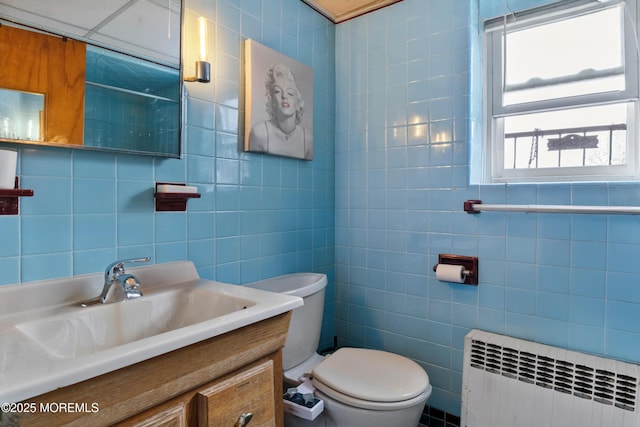 1020 Raritan Ave, Highland Park, NJ 08904 - bathroom with radiator heating unit, tile walls, toilet, and vanity
