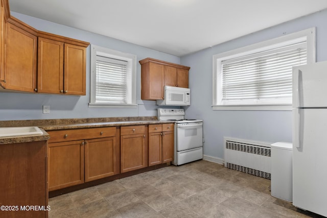 1020 Raritan Ave, Highland Park, NJ 08904 - kitchen featuring white appliances, radiator, brown cabinetry, and plenty of natural light