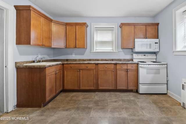 1020 Raritan Ave, Highland Park, NJ 08904 - kitchen with white appliances, a sink, and brown cabinetry