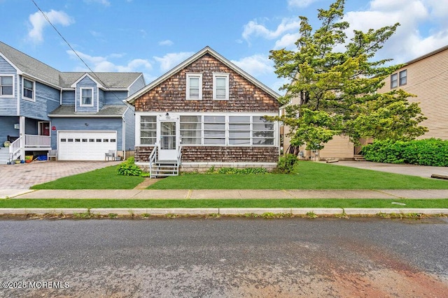 110 2nd Ave, Seaside Park, NJ 08752 - view of front of property with driveway, a garage, a front lawn, and entry steps