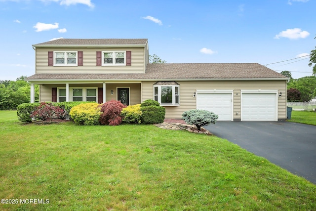 6 Keats Ct, Manalapan, NJ 07726 - traditional home featuring an attached garage, asphalt driveway, a front lawn, and a shingled roof