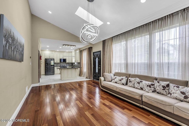 43 Saint Johns Dr, Freehold, NJ 07728 - living room with light wood-style flooring, baseboards, vaulted ceiling, a chandelier, and recessed lighting
