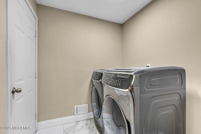 43 Saint Johns Dr, Freehold, NJ 07728 - laundry area featuring washing machine and clothes dryer, marble finish floors, and baseboards