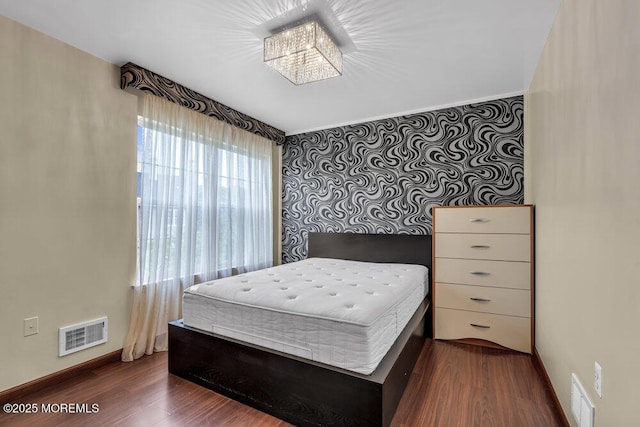 43 Saint Johns Dr, Freehold, NJ 07728 - bedroom with dark wood finished floors, baseboards, and a chandelier