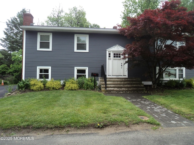 127 Hulick St, Long Branch, NJ 07740 - bi-level home with a chimney, entry steps, and a front lawn
