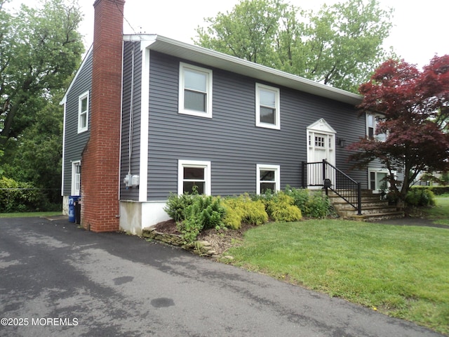 127 Hulick St, Long Branch, NJ 07740 - view of front of house featuring a chimney and a front yard