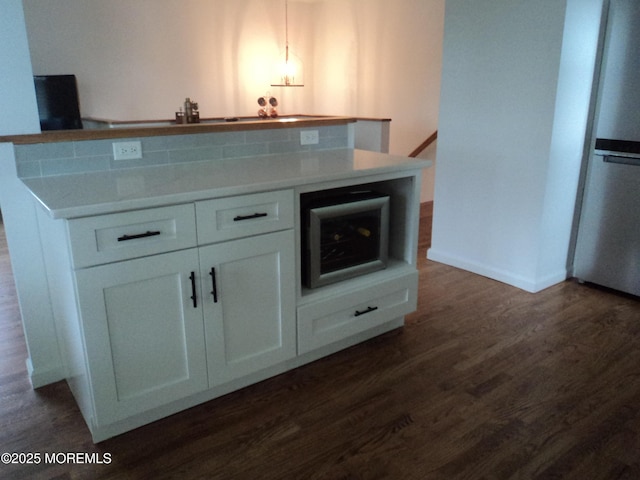 127 Hulick St, Long Branch, NJ 07740 - kitchen with white cabinets, dark wood-style flooring, a center island, light countertops, and baseboards