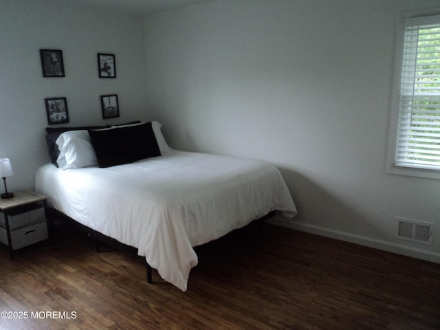 127 Hulick St, Long Branch, NJ 07740 - bedroom with wood finished floors, multiple windows, and baseboards
