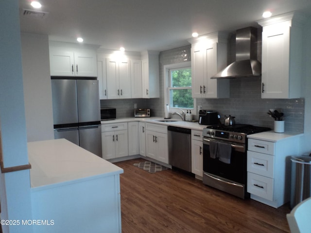 127 Hulick St, Long Branch, NJ 07740 - kitchen with stainless steel appliances, wall chimney exhaust hood, white cabinetry, backsplash, and dark wood-type flooring
