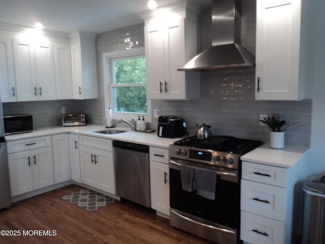 127 Hulick St, Long Branch, NJ 07740 - kitchen with appliances with stainless steel finishes, wall chimney range hood, a sink, light countertops, and white cabinetry