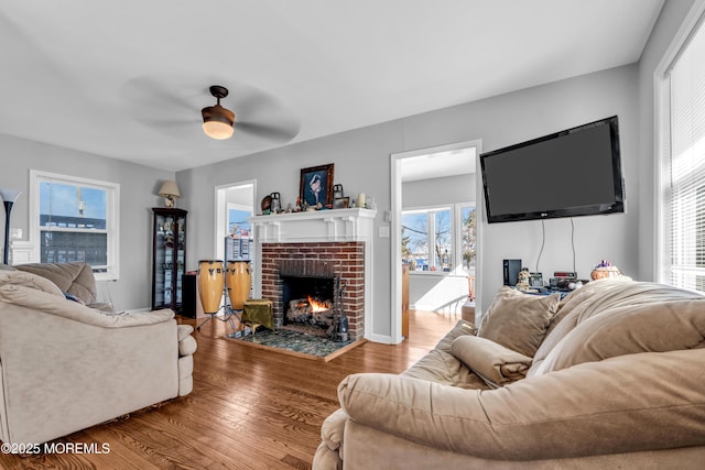 1204 River Rd, Belmar, NJ 07719 - living area featuring wood finished floors, a brick fireplace, and a ceiling fan