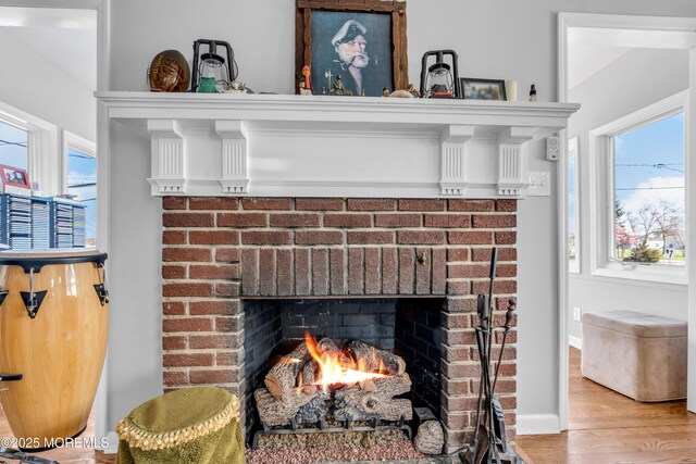 1204 River Rd, Belmar, NJ 07719 - detailed view of a fireplace, wood finished floors, and baseboards