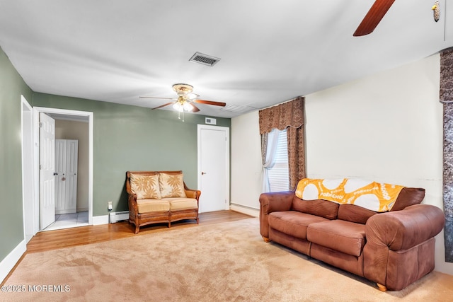 830 Atlantic City Blvd, Bayville, NJ 08721 - carpeted living area featuring a ceiling fan, baseboard heating, baseboards, and a baseboard radiator
