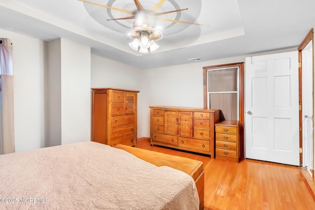 830 Atlantic City Blvd, Bayville, NJ 08721 - bedroom featuring light wood-style floors, a raised ceiling, and ceiling fan