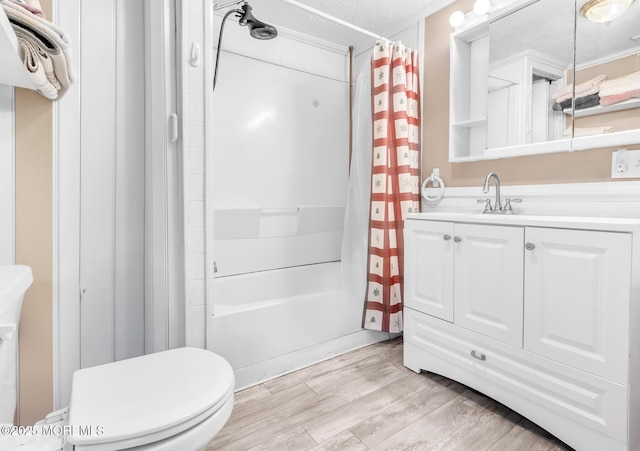830 Atlantic City Blvd, Bayville, NJ 08721 - bathroom featuring wood finished floors, shower / bathtub combination with curtain, vanity, toilet, and a textured ceiling