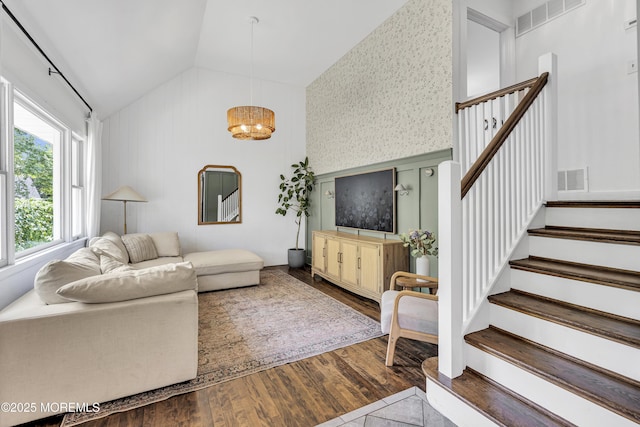17 Maplewood Dr, Middletown, NJ 07748 - living area with lofted ceiling, stairway, wood finished floors, a chandelier, and wallpapered walls