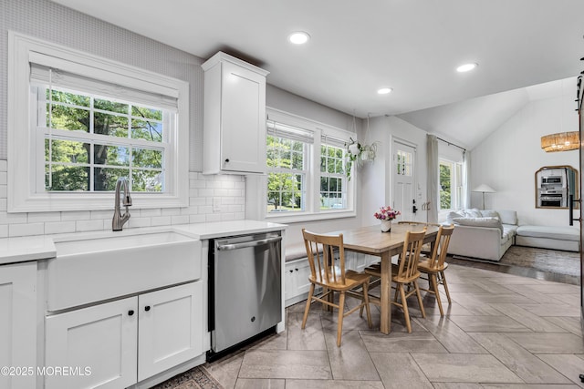 17 Maplewood Dr, Middletown, NJ 07748 - kitchen featuring stainless steel dishwasher, a sink, light countertops, lofted ceiling, and white cabinetry