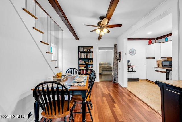 908 Green Grove Rd, Ocean Twp, NJ 07712 - dining room with beamed ceiling, a ceiling fan, stairway, light wood-style flooring, and baseboards
